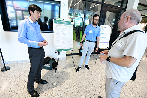 Bellini College students show and explain their research poster.