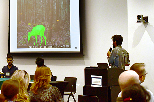 A Bellini student discusses his research during a panel discussion at the symposium.