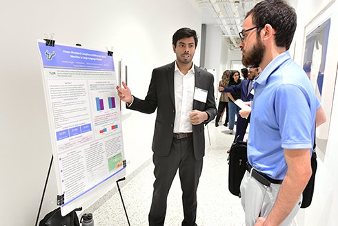 Bellini student discussing his research poster at the symposium