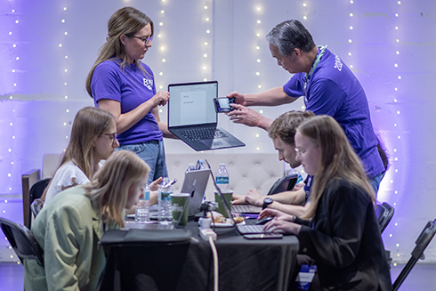 Attendees of the Hackathon discuss problems they are trying to solve with AI