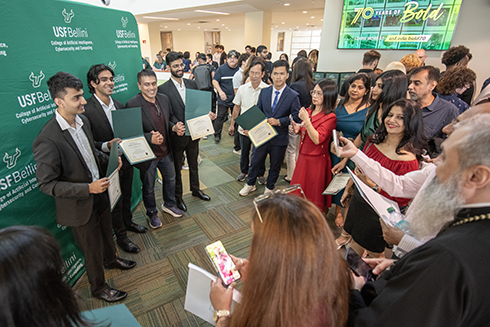 Students pose for photos outside the induction ceremony.