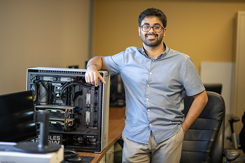 USF Bellini Assistant Professor Anshuman Chhabra inside his lab standing next to a computer.