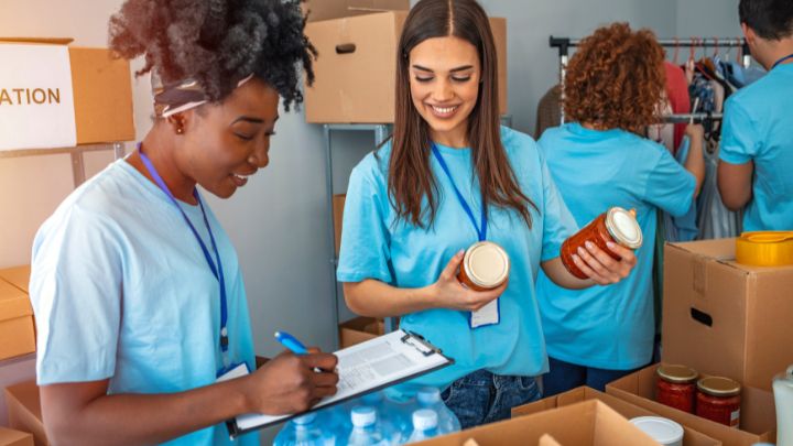 women sorting food donations into boxes