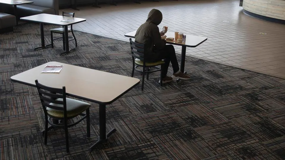 student sits alone eating