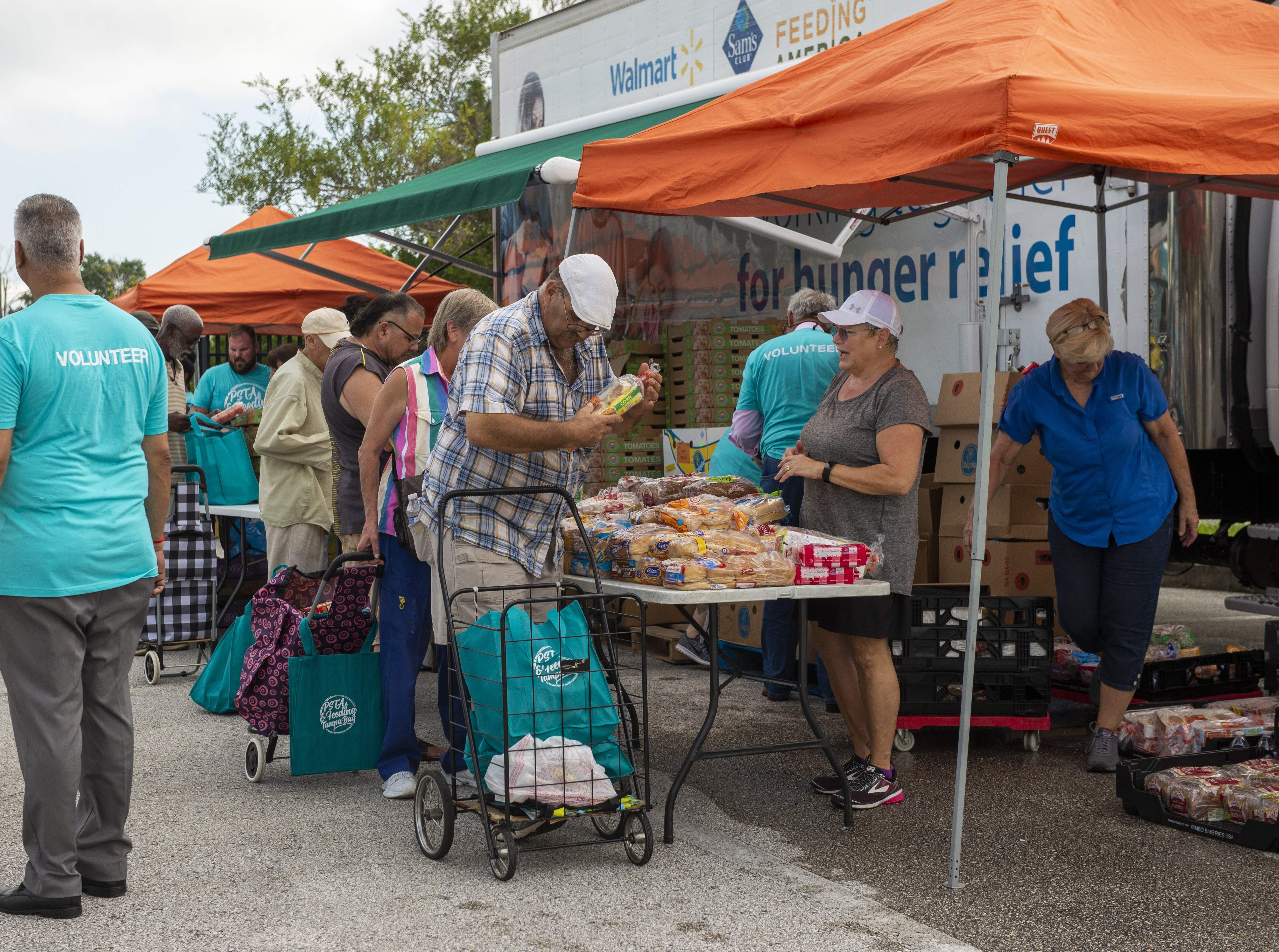 Crowds gathering around a mobile food pantry