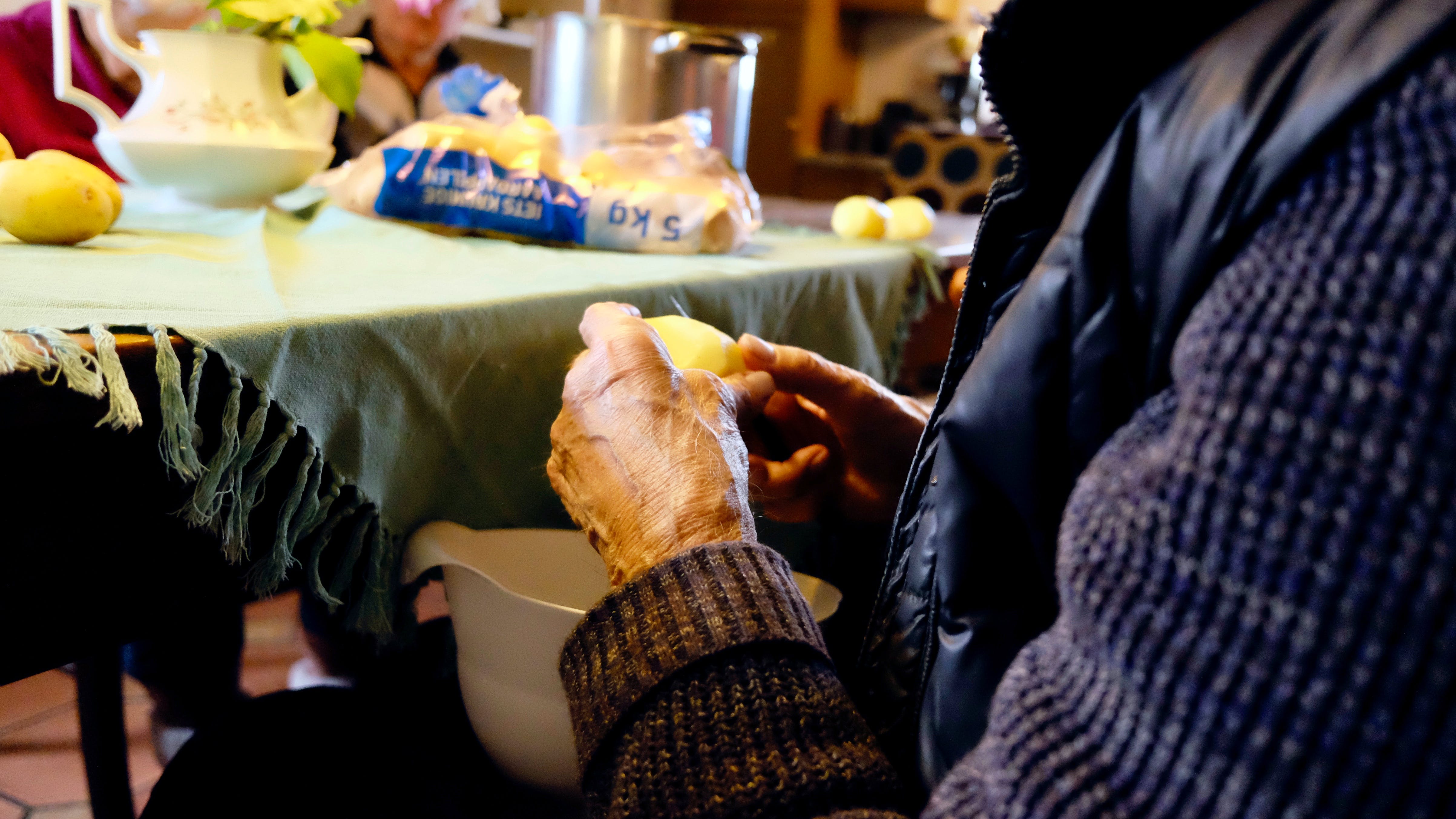 Old man holding fruit