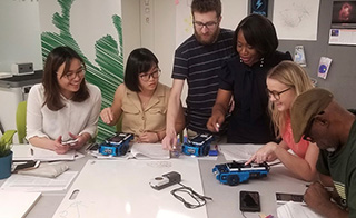 Dr. Sears and student programming a rover