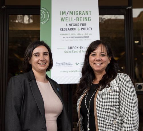 Im/migrant well-being: A nexus for research & policy conference. In this picture, the co-founders of the collaborative are shown: Dr. Liza Aranda and Dr. Eli Vaquera.
