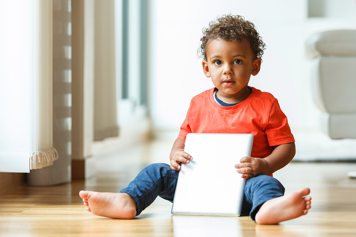 small boy seated on the floor