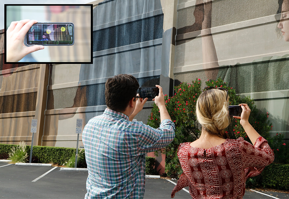 man and woman viewing a building with cell phones