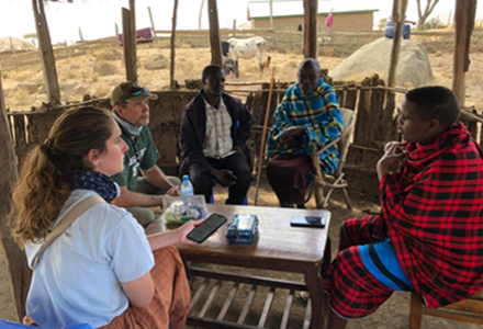 people sitting around table in a hut