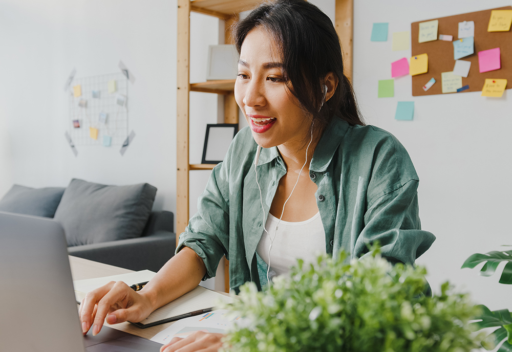 smiling woman working on a laptop