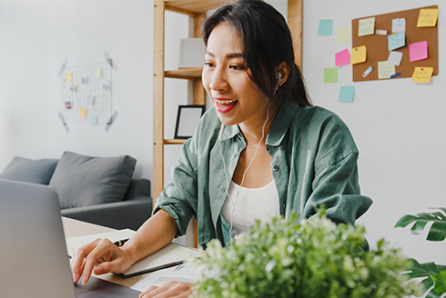 smiling woman working on a laptop