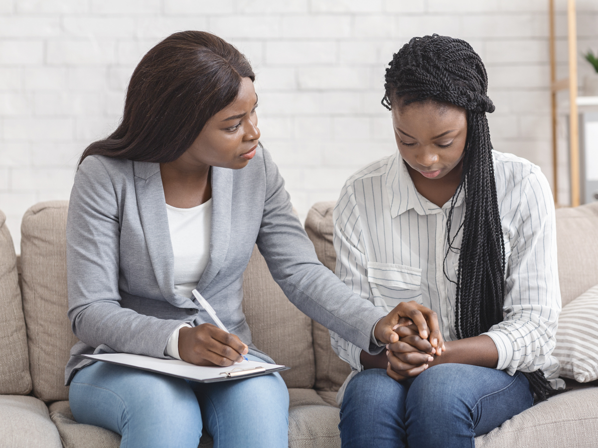 Black woman comforts teen