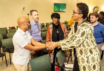 Dr. Gloria Browne-Marshall speaks with attendees at the close of the event
