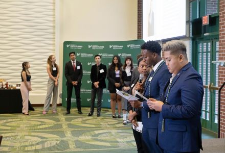 Afiya Thompson, Myles McCants, and Tony Tran assist with inducting new members. (Photo by Marc Edwards Photographs)