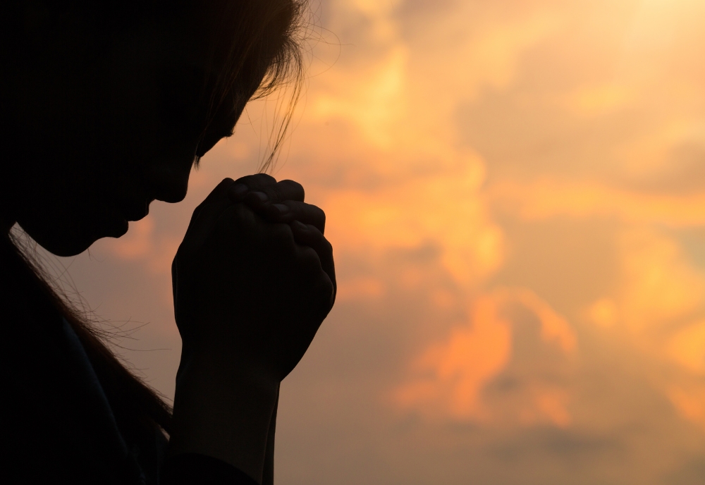 profile of person bowed in prayer