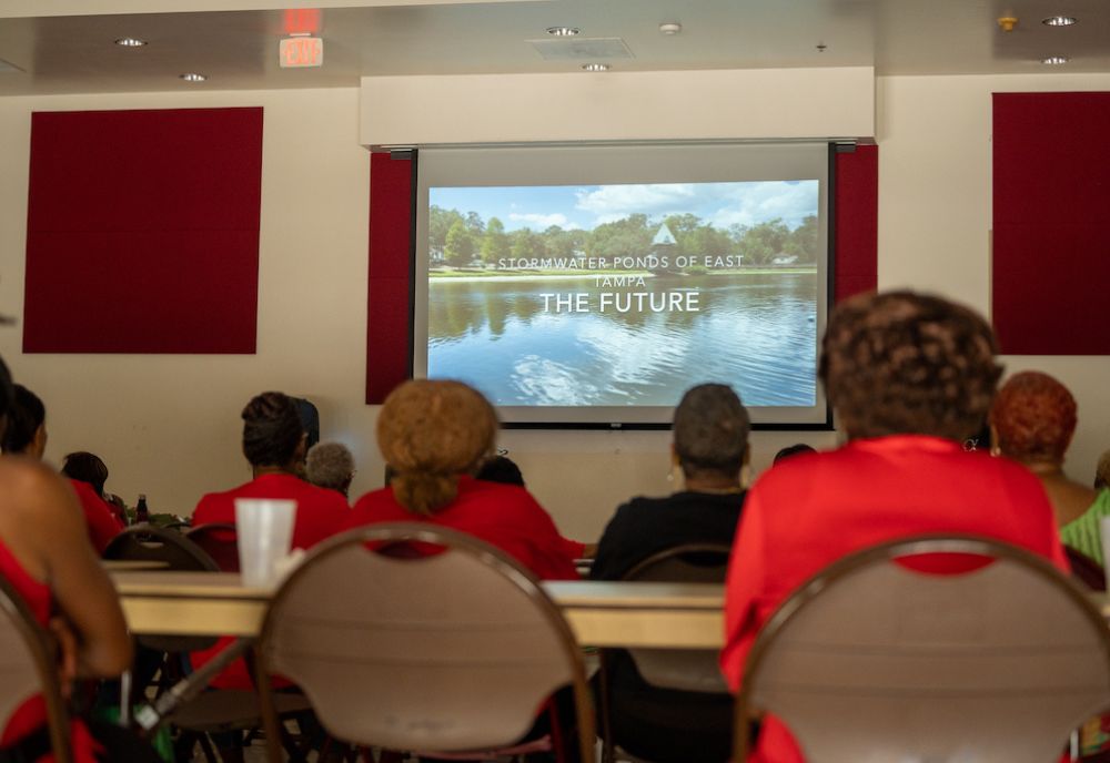 A group of East Tampa residents gather to watch student films about the surrounding stormwater retention ponds in their community. (Photo courtesy of Evan Stout)