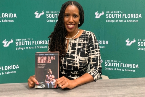 Elizabeth Hordge Freeman with a copy of her book Second Class Daughters