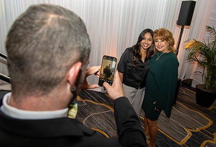 Colleen Chappell (right) posing for a photo with symposium attendee (middle). (Photo courtesy of John Tipton & Mridula Singh)