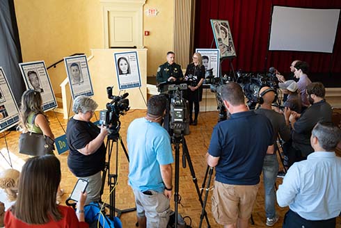 camera crews video news conference with police