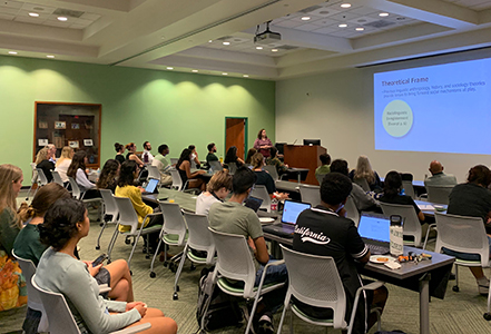 Rebecca Campbell-Montalvo speaks to the crowd of attendees at USF book event. (Photo courtesy of Oxana Sidorova)