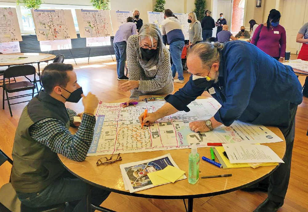 Stephen Benson (left) working with residents (middle and right) of the Tampa Heights neighborhood on a plan for the area. (Photo courtesy of Stephen Benson) 