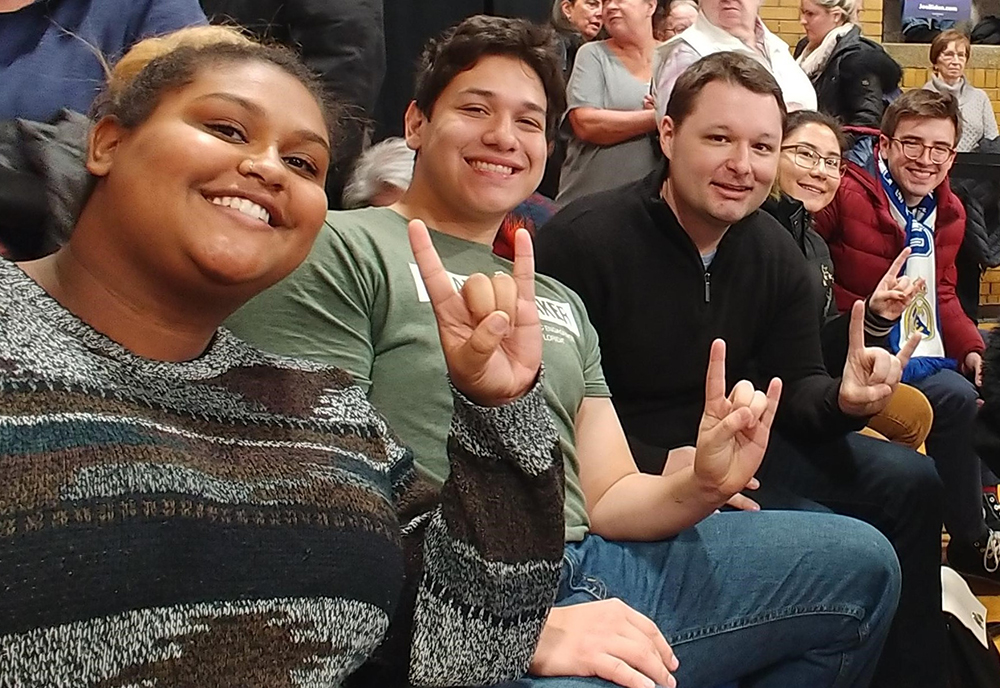 (From Left) USF students Asia Anderson, Eduardo Fox-Velazquez, associate professor Joshua Scacco, USF students Camila Cernawsky Nakandakari, and Aldo Puccinion, on a research field trip to the Iowa caucuses in 2020. (Photo courtesy of Joshua Scacco)