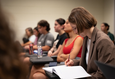 A student in the American National Government class taking notes of the Bulls in Action event. (Photo by Corey Lepak)