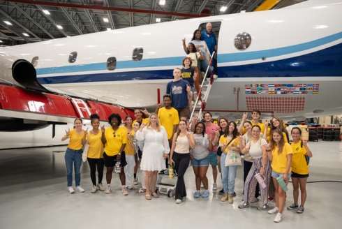 Dr. Jennifer Collins, professor in the School of Geosciences and principal investigator on Weather, Climate, and Society REU, with two REU groups at USF this summer, one from the Tampa campus, and one from the St. Petersburg campus, on a P-3 Orion plane which is used to fly into hurricanes. (Photo by Corey Lepak)