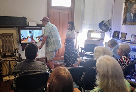 Hannah demonstrating the new technology to a Brooksville community during the museum's unveiling party. (Photo by Dr. Jennifer Knight)