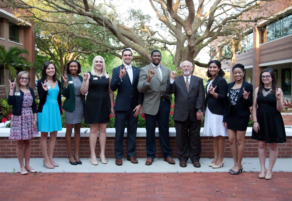Jeremy Lomax (fifth from right) standing next to former College of Arts and Sciences Dean Eric Eisenberg (fourth from right) with the DSLS class of 2014. (Photo courtesy of Jeremy Lomax)