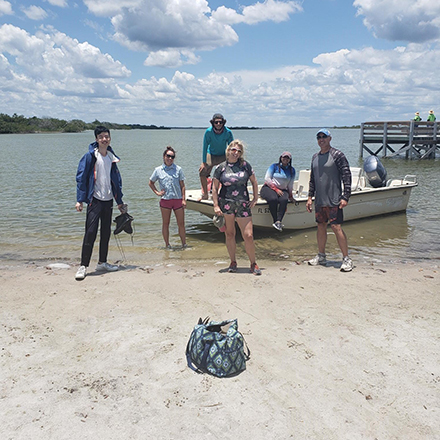 (From Left) Yijie-Zhu, PhD student of Dr. Jennifer Collins, Joanne Muller, researcher from FGCU, followed by her graduate student. (Middle) Dr. Jennifer Collins, another graduate student of Joanne Muller, and (Right) Chris Landsea from the National Hurricane Center. The team is seen gathering cores of sediment to analyze and identify past hurricane activity. (Photo courtesy of Jennifer Collins)