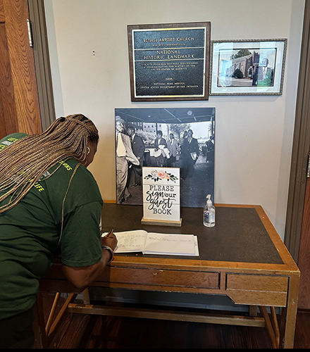 April Edwards signs Bethel Baptist Church guest book.