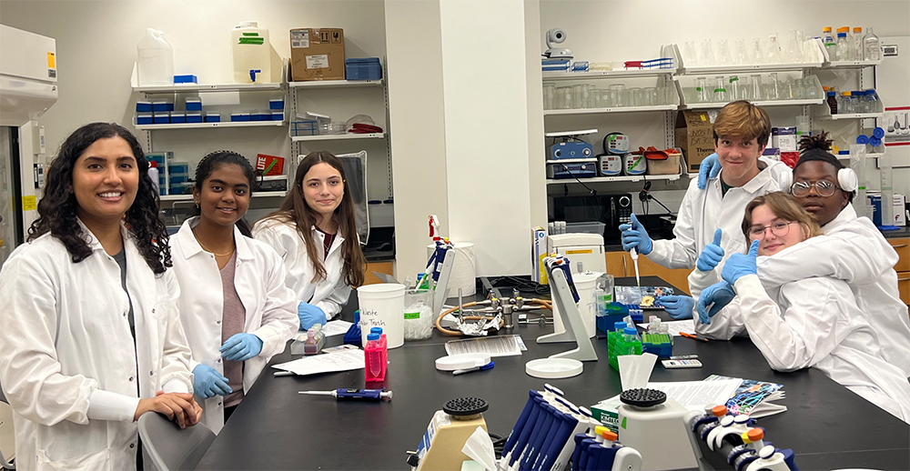 Krishna Rentachintala (far left) leads Freedom High School students in an activity in the genetics laboratory (Photo courtesy of Sandy Westerheide)