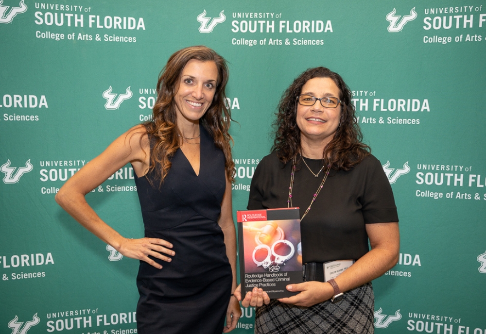 CJRP Co-Directors Dr. Bryanna Fox (left) and Dr. Edelyn Verona (right) at the celebratory launch of their new book, “Routledge Handbook of Evidence-Based Criminal Justice Practices.” (Photo by Corey Lepak)