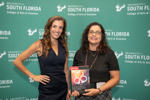 CJRP Co-Directors Dr. Bryanna Fox (left) and Dr. Edelyn Verona (right) at the celebratory launch of their new book, “Routledge Handbook of Evidence-Based Criminal Justice Practices.” (Photo by Corey Lepak)
