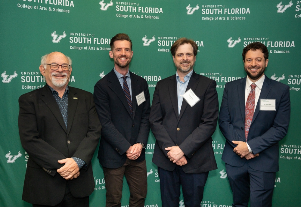 (From left) Dr. Eric M. Eisenberg, Senior Vice President for University-Community Partnerships; Dr. Michael DeJonge, James F. Strange Chair; Dr. Steven M. Vose, assistant professor in the Department of History and holder of the Bhagwan Suparshvanatha Professorship in Jain Studies at the University of Colorado-Denver; and Dr. Justin Henry, Bhagwan Padma Prabhu Endowed assistant professor. (Photo by Corey Lepak)