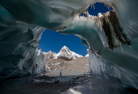 A guide exiting a carved-out cave in Nepal during a glacier exploration in 2019. (Photo courtesy of Dr. Jason Gulley)