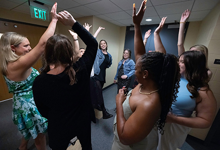 Performers share a moment of connection backstage. (Photo by Laura Lyon Photography)