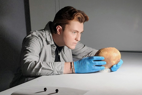 Eylward’s interdisciplinary approach to analyzing skeletal remains harnesses innovative technology as well as traditional, hands-on methods. (Photo courtesy of Aiden Eylward)