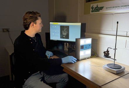 Eylward digitizing an article in the IDEx office. (Photo courtesy of Aiden Eylward)