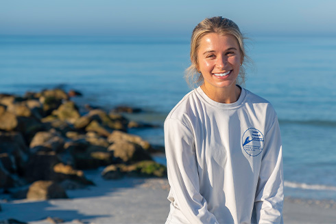 Libby Royer surveys changes to Treasure Island beaches following Hurricanes Helene and Milton [Photos by Andres Faza, University Communications and Marketing]