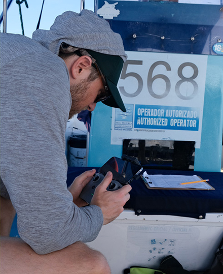 Integrative Biology professor Lucas Griffin works with equipment in the field. (Photo by Jessica Bujouves)