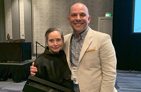 Lorena Madrigal, professor, (left) with Jonathan Bethard, associate professor, (right) — who nominated her — during the American Association of Biological Anthropologists awards ceremony in March 2025. (Photo courtesy of Lorena Madrigal)