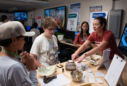 Laura Harrison (right) working with a student at this year's USF Archaeology + Art Camp. (Photo credit: Corey Lepak)
