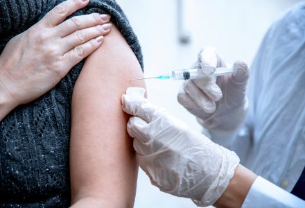 person receiving vaccination in their arm