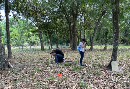 Jonathan Rodriguez (anthropology department and LHI) and Sophia Almeida (history department and USF IDEx) take photos of markers. (Photo courtesy of IDEx)