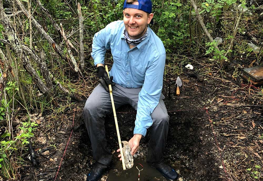 USF College of Arts and Sciences applied anthropology doctoral candidate Jaime Rogers holding a colossal oyster from a 1,500-year-old midden, now located in the intertidal zone. Many of these archaeological oysters are twice the size of oysters in the estuary today. (Photo courtesy of Jaime Rogers)