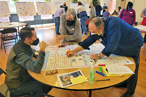 Stephen Benson (left) working with residents (middle and right) of the Tampa Heights neighborhood on a plan for the area. (Photo courtesy of Stephen Benson)